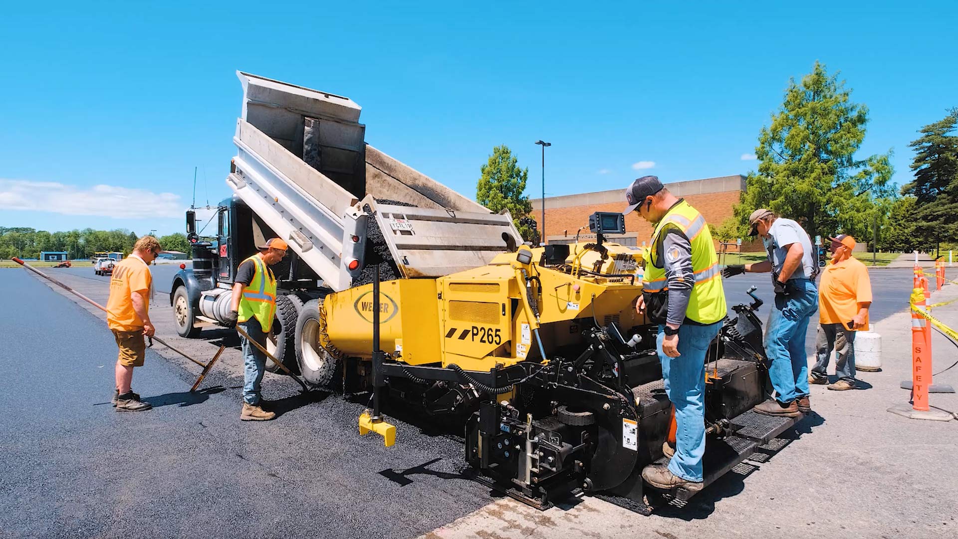 starting paving at old pavement with dump truck loading asphalt